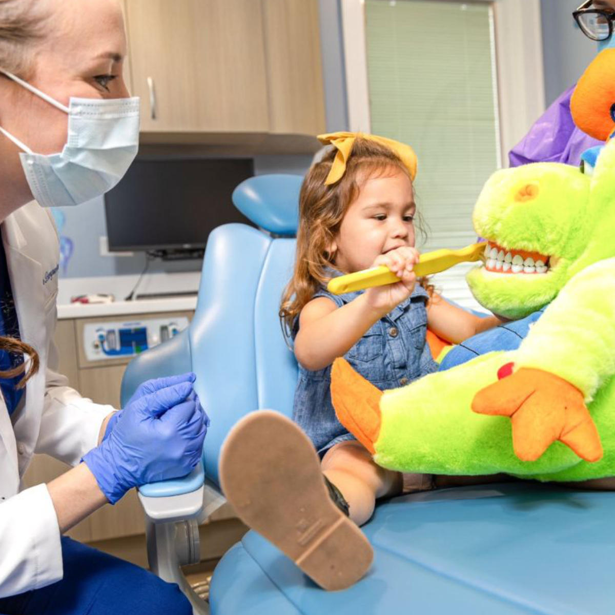 child patient sitting with stuffed animal