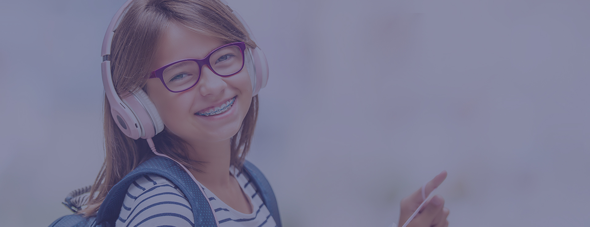 Kid orthodontics girl with braces happy and listening to music