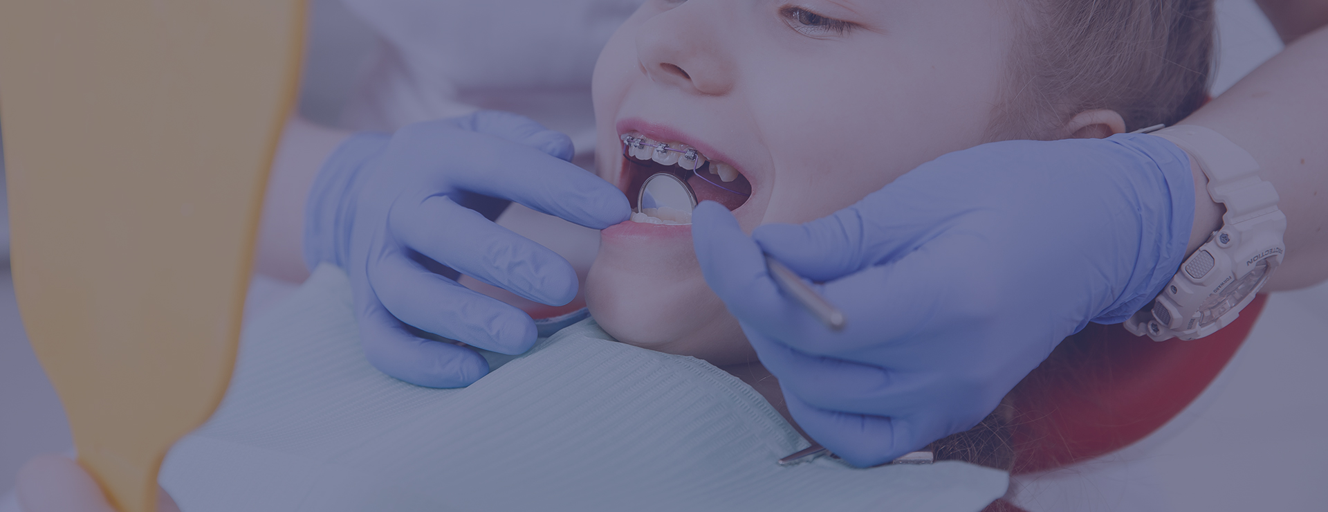 child getting braces checked at orthodontist